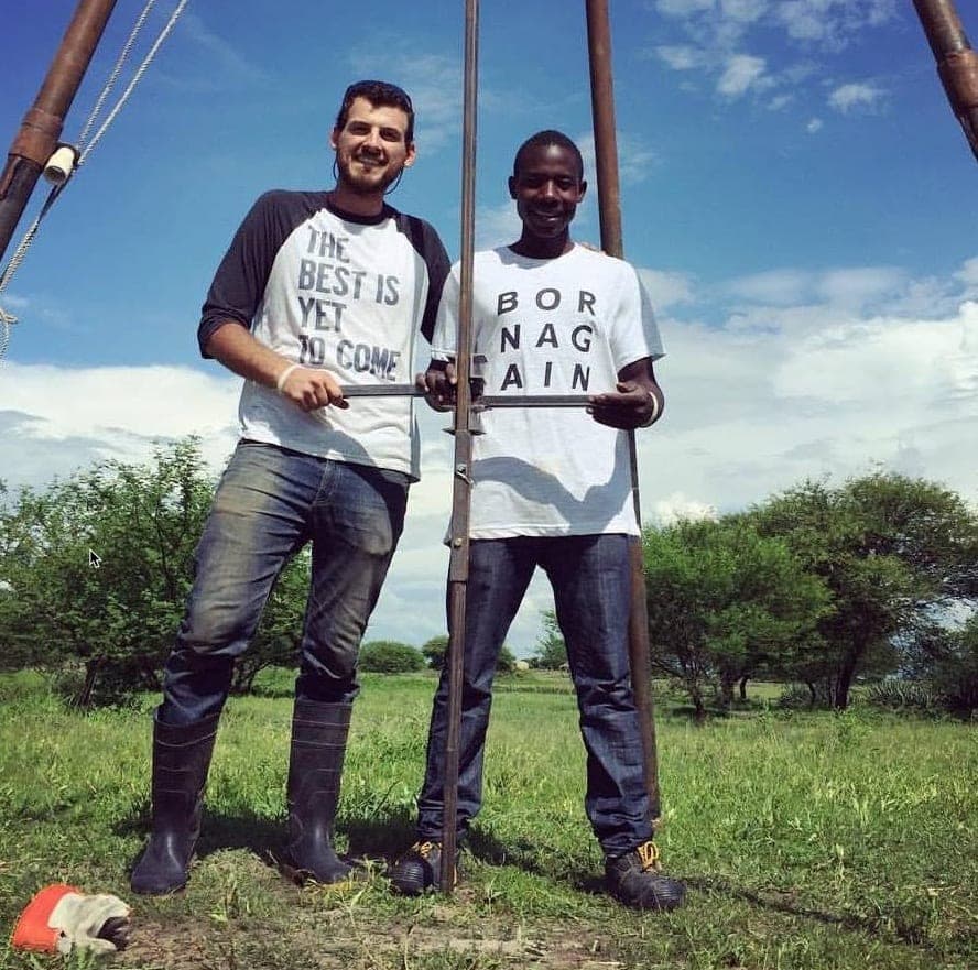 Andrew and Kisula at a well-drilling rig in rural Tanzania